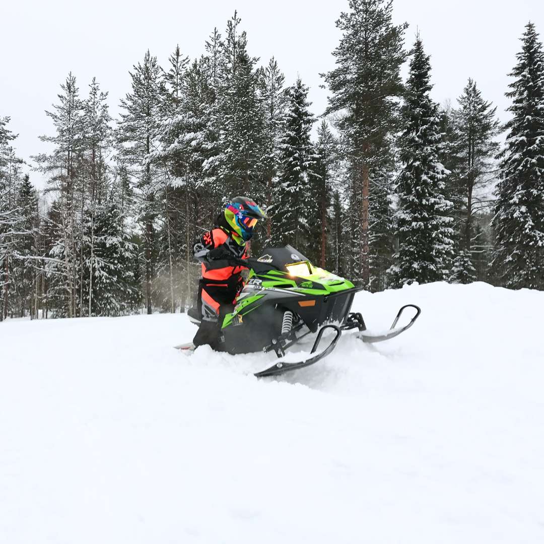 Child riding a mini-snowmobile at Lapland Winter Park Rovaniemi